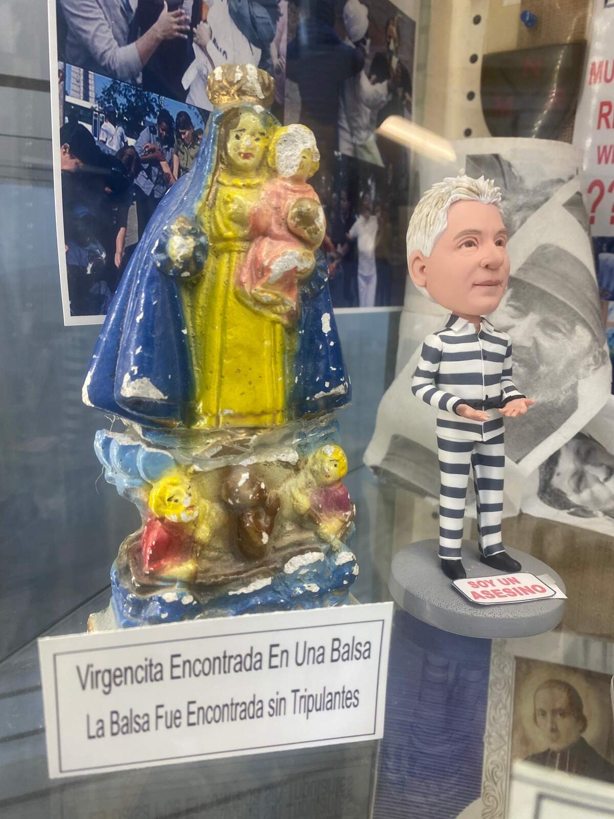 An image of the Virgin of Charity found on an empty raft, symbolizing the exodus of rafters who leave Cuba in flimsy vessels and never reach the shores of Florida. To the right, an image of Cuba’s unelected leader, Miguel Díaz-Canel, who is responsible for the intensification of repression on the island.